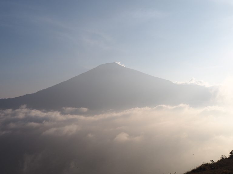 Mountain peak above the clouds in soft evening light