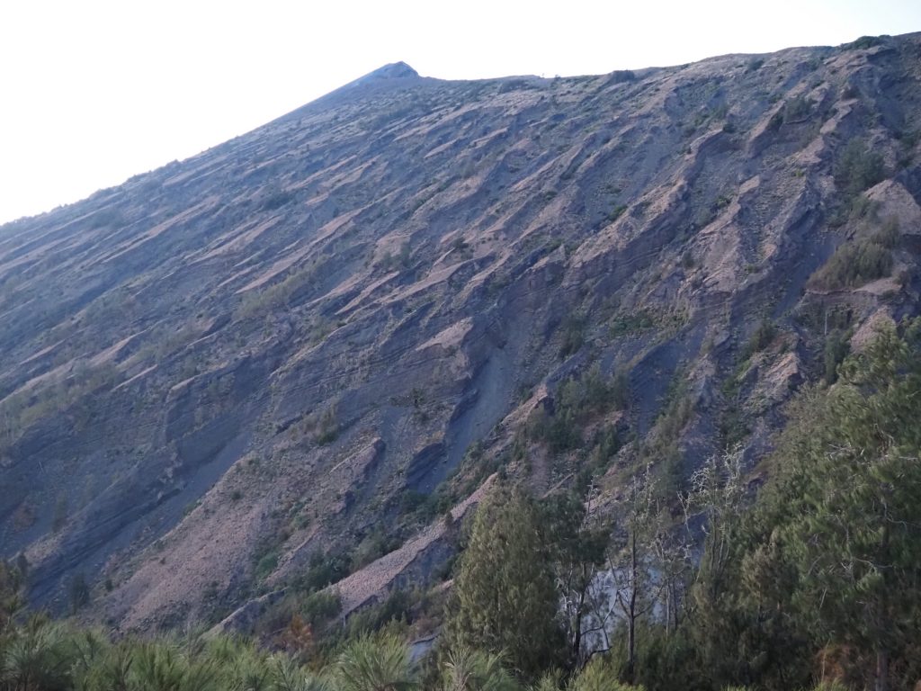 Steep volcanic slope of Mount Rinjani at sunrise